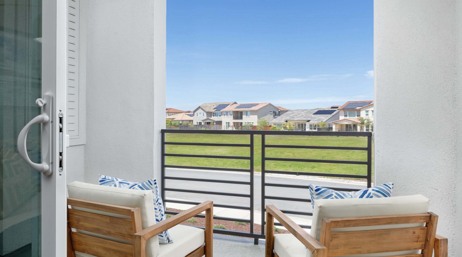 a balcony with a chair and a table